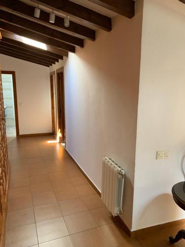 a hallway with white walls and a tile floor at Casa Rural Erre Q Erre in Oreña