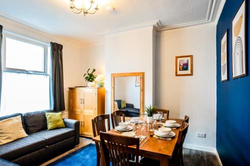 a living room with a table and a couch at The Tigers Townhouse in Leicester