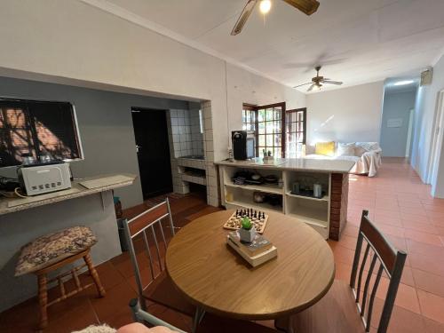 a kitchen and living room with a table and a television at Casa Bravo - Pilgrims Palace in Pretoria