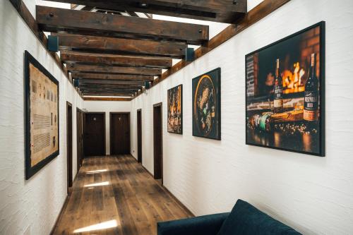 a hallway with many pictures on the walls at Nestville Apartments in Hniezdne