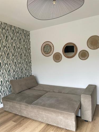 a bed in a room with a wall at Maison cosy avec jacuzzi in Néant-sur-Yvel