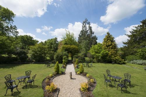 a garden with tables and chairs and a pathway at Woodlands Lodge Hotel in Bartley