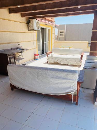 a group of beds sitting on top of a patio at Lovely Villa 5- bedroom with Overflow Pool with Nice Garden at Green Oasis Resort in Alexandria