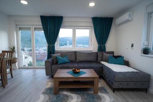 a living room with a couch and a table at Sunset View Apartments in Mostar