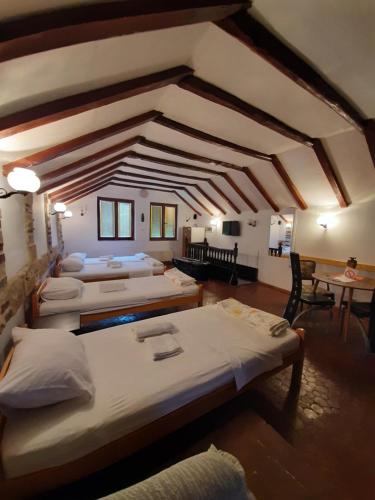 a large room with four beds and a ceiling at Apartman Kamen 1 in Negotin