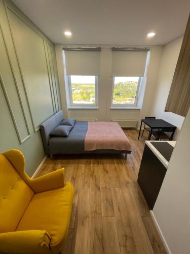 a bedroom with a bed and a couch and a table at 22 Airport Apartment in Vilnius