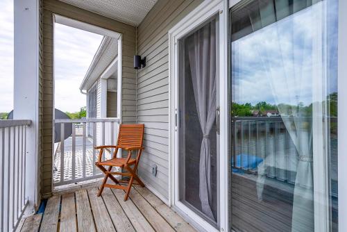 a rocking chair on a porch with a sliding glass door at Beach1 River to Bay Getaway in Wasaga Beach