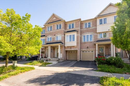 a brick apartment building with a driveway at Beautiful Townhouse In Toronto in Toronto