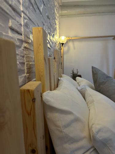 a row of pillows are lined up against a wall at Macide Hanım Konağı in Ayvalık