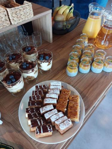 a table with a plate of different types of desserts at Apartamenty i Pokoje Złote Piaski in Jastrzębia Góra