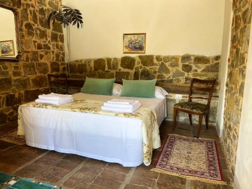 A bed or beds in a room at Podere Belvedere Tuscany