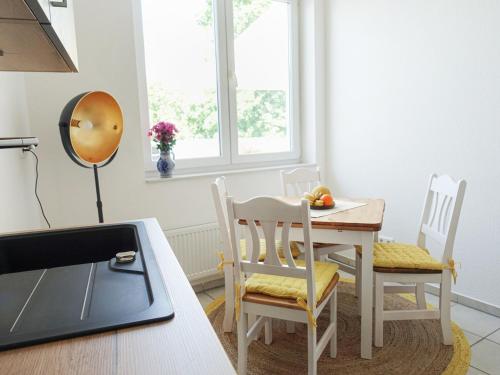 a kitchen with a table and chairs in a room at Penthaus Kranichholz in Lüdinghausen