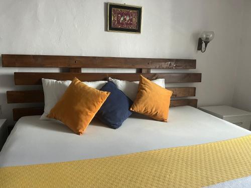 a bed with four pillows on top of it at Macide Hanım Konağı in Ayvalık