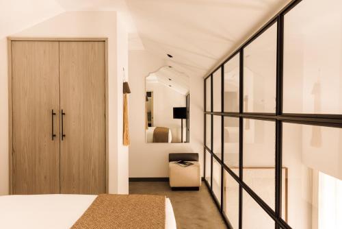 a bedroom with a bed and a sliding glass door at The Rebello Hotel & Spa - Small Luxury Hotels Of The World in Vila Nova de Gaia