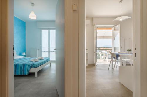a bedroom with a bed and a dining room with a table at Residence Mizar in Pietra Ligure