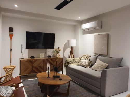 a living room with a couch and a tv at Mako 54 in Puerto Vallarta