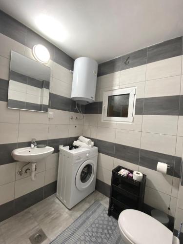 a bathroom with a washing machine and a sink at Villa Marija in Cetinje
