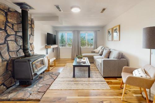 a living room with a fireplace and a couch at Rainbow Connection in Tabernash
