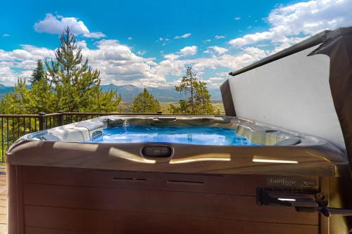 a hot tub on a deck with an umbrella at Rainbow Connection in Tabernash