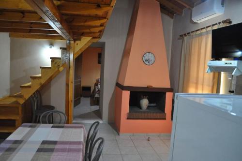 a living room with a fireplace with a clock on it at Marathias sea view in Lákhion