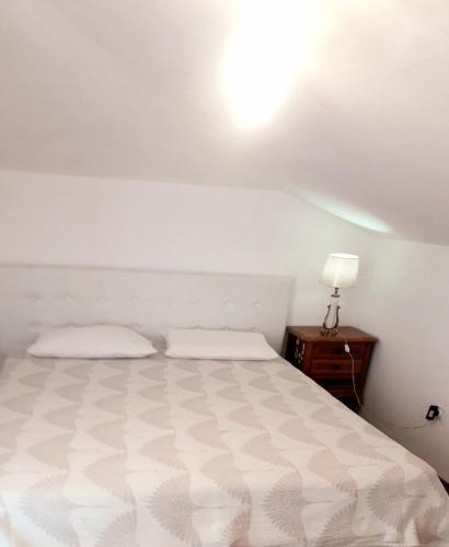 ein Schlafzimmer mit einem Bett und einer Lampe auf einem Tisch in der Unterkunft Elizabeth apartment 2 bedroom sityBudva in Budva