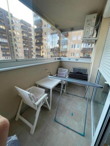 a balcony with a glass table and a chair at Sarajevo Otoka - Stan na dan in Sarajevo