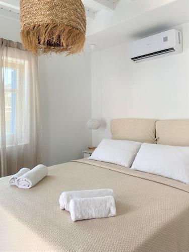 a bedroom with a large bed with towels on it at Cordiale Mykonos in Ornos