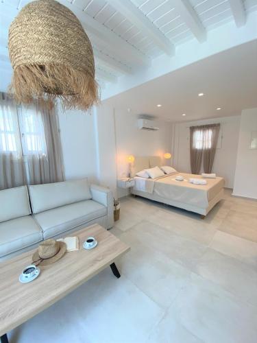 a living room with a couch and a bed at Cordiale Mykonos in Ornos