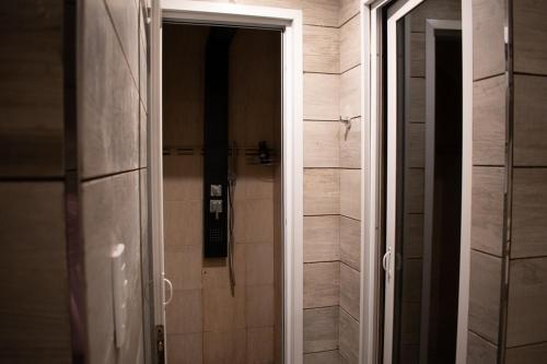 an open door to a shower in a bathroom at Sonidos Del Bosque in Mar de las Pampas