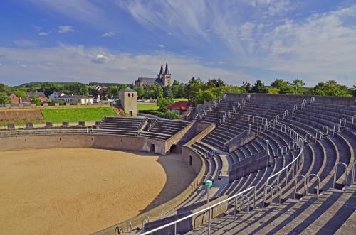 an amphitheater with empty seats in a stadium at Hotel Neumaier in Xanten