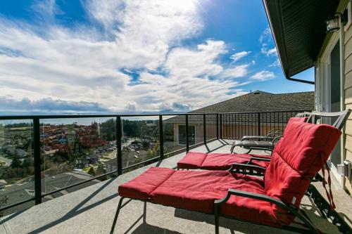 a balcony with two chairs and a view of a city at Eagle's View Penthouse in Victoria