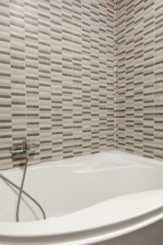 a white bath tub in a bathroom with a window at Red Rose in Marsalforn