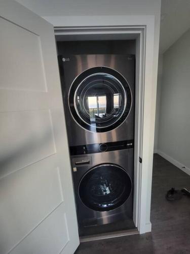a washer and dryer in a room at Eagle's View Penthouse in Victoria