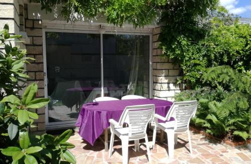 a purple table and chairs on a patio at Nice family studio in villa Sceaux 600m RER B direct to Notre-Dame in Sceaux