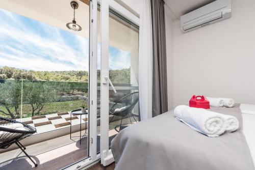 a bedroom with a bed and a balcony with a view at Furesta in Kraj