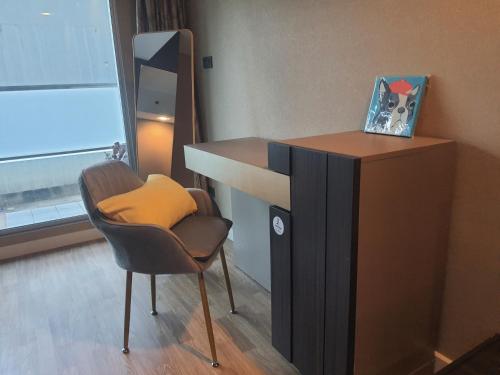 Zimmer mit einem Schreibtisch, einem Stuhl und einem Spiegel in der Unterkunft Baan Nonzee Condo in Bangkok