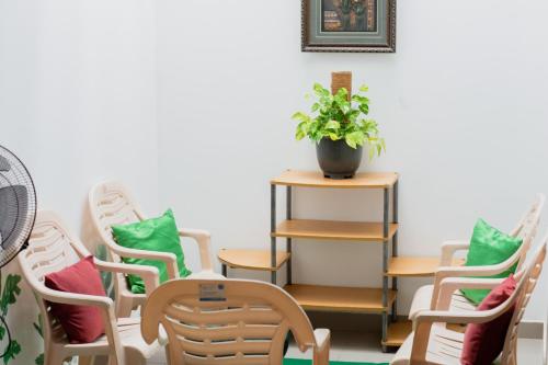 a group of chairs and a table with a potted plant at Marette Holiday Bungalow in Moratuwa