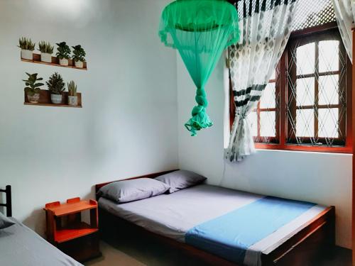 a bed in a room with a window at Marette Holiday Bungalow in Moratuwa