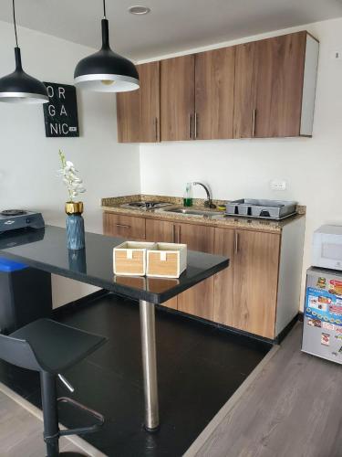 a kitchen with a table and a counter top at 4 Apartaestudio Cedritos completo in Bogotá