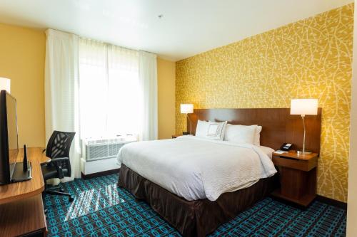 a hotel room with a bed and a television at Fairfield Inn & Suites by Marriott Bay City, Texas in Bay City