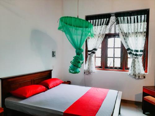 a bedroom with a bed and two windows with curtains at Marette Holiday Bungalow in Moratuwa