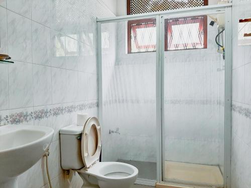 a bathroom with a toilet and a sink and a shower at Marette Holiday Bungalow in Moratuwa