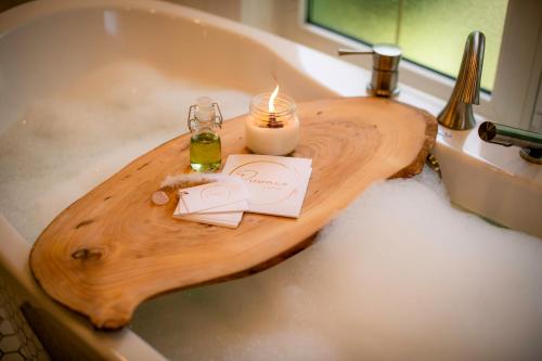 a wooden board in a sink with a candle at HoriZen Bnb in Leamington