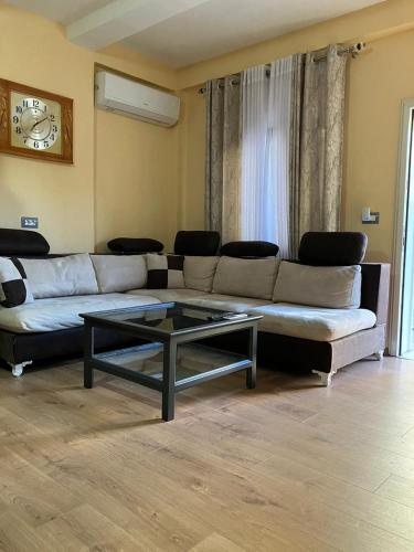 a living room with a couch and a coffee table at Vila Murati in Tirana