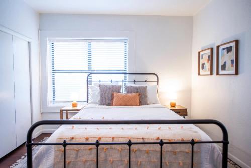 a bedroom with a bed and a window at Classy 1927 Uptown Tudor 4 min to Magnolia in Waco