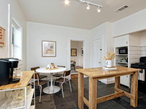 a kitchen and dining room with a table and chairs at Classy 1927 Uptown Tudor 4 min to Magnolia in Waco