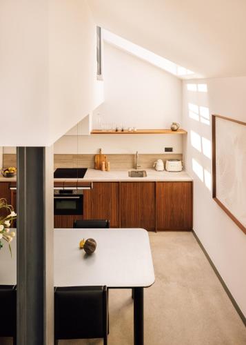 a kitchen with a white table and a sink at The Rebello Hotel & Spa - Small Luxury Hotels Of The World in Vila Nova de Gaia