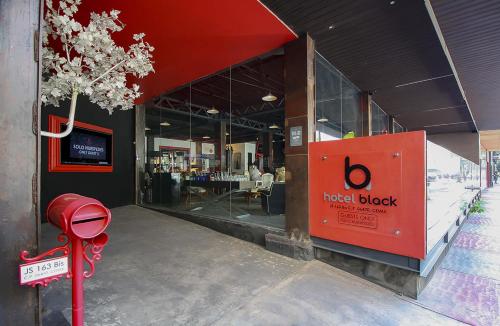 a hotel block with a red sign in front of a building at Hotel Black Boutique in Mexico City