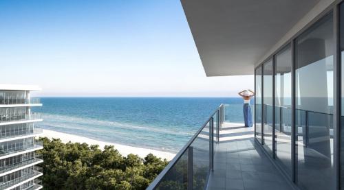 a view of the ocean from the balcony of a building at Wave Międzyzdroje Resort & SPA in Międzyzdroje