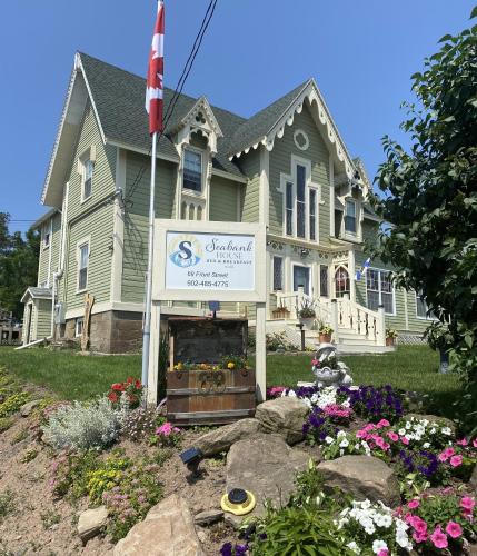 a house with a sign in front of it at Seabank House Bed and Breakfast Ahoy in Pictou